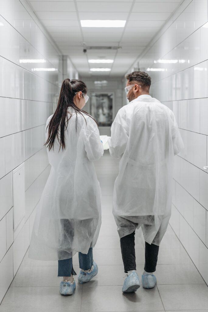 Two scientists walking down a hallway